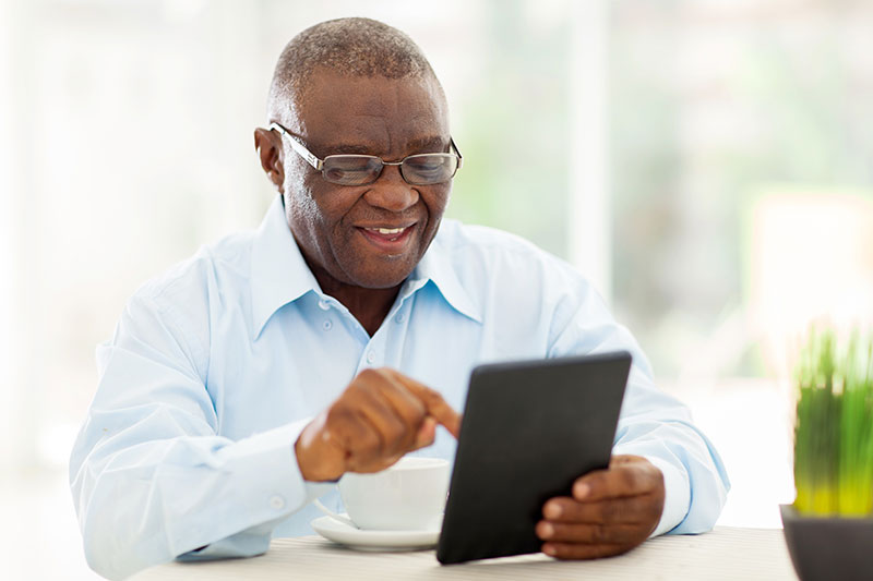 Mature man using a tablet 