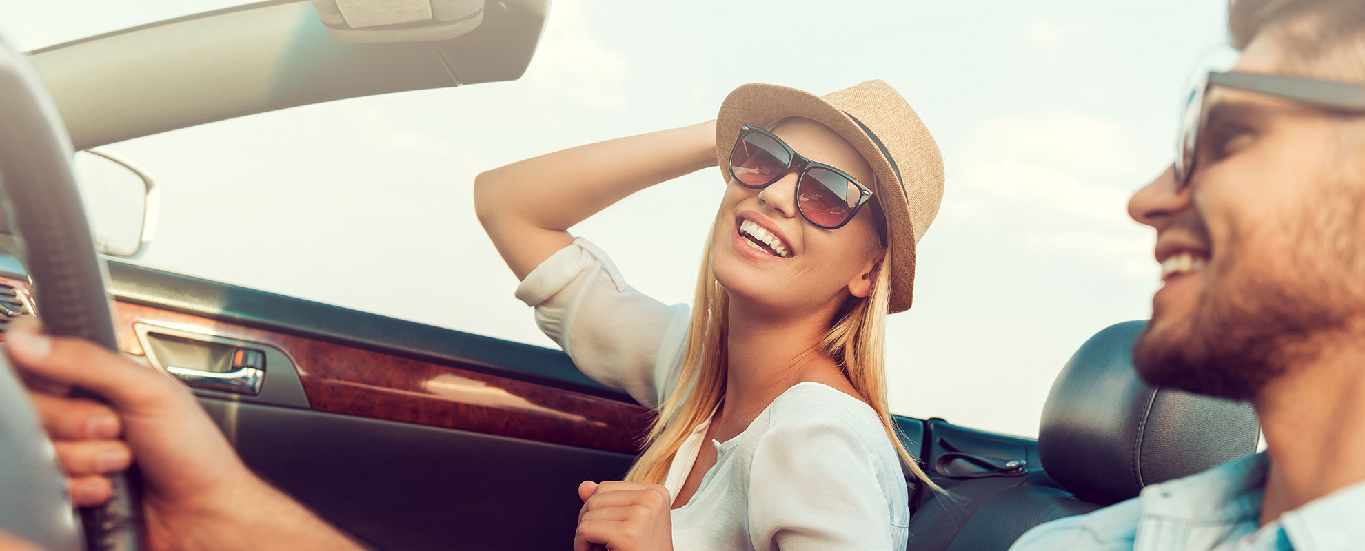 Couple wearing sunglasses in a car